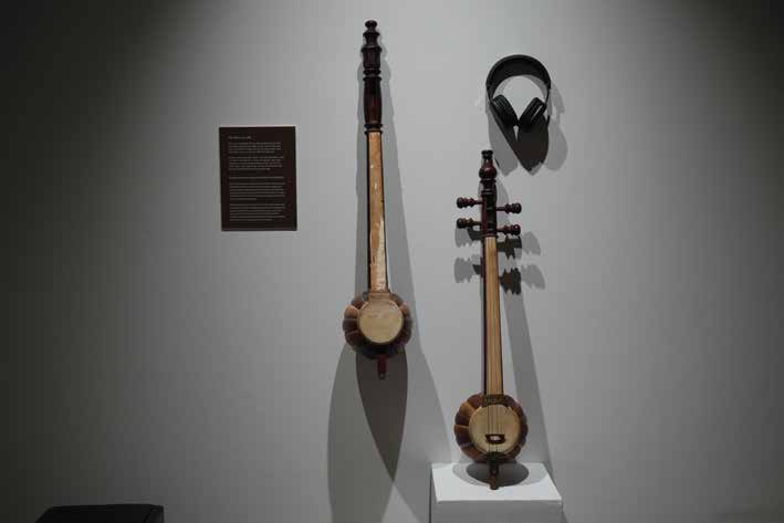 A century-old traditional lute beside a restoration listening station.